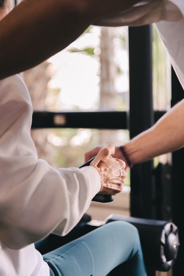 Trainer and client shaking hands at the gym