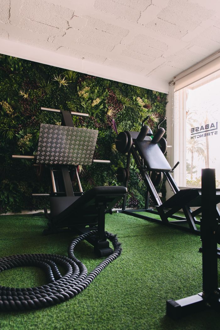Training room with a green wall and artificial turf